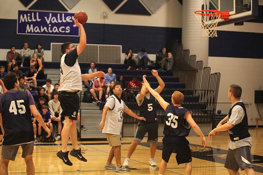 Jumping in the middle of the lane, business teacher Kurt Bangle shoots the ball.