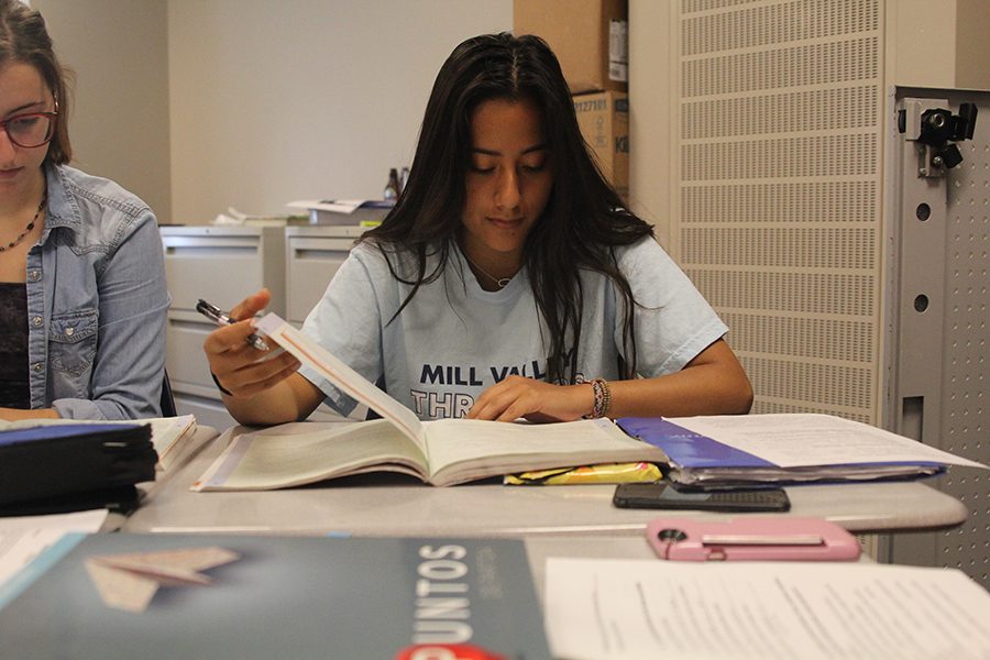 Using her textbook during a test, junior Zurieli Rojas is an example of what students selected to take the STAMP biliteracy exam looked like on Tuesday, Apr. 20.