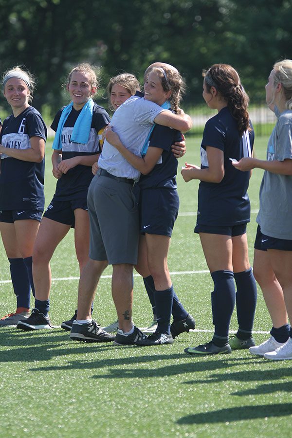 During the awards ceremony, senior Payge Bush hugs head coach Arlan Vomhof.