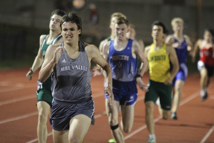 Senior Justin Grega gives it his all as he finishes his event.