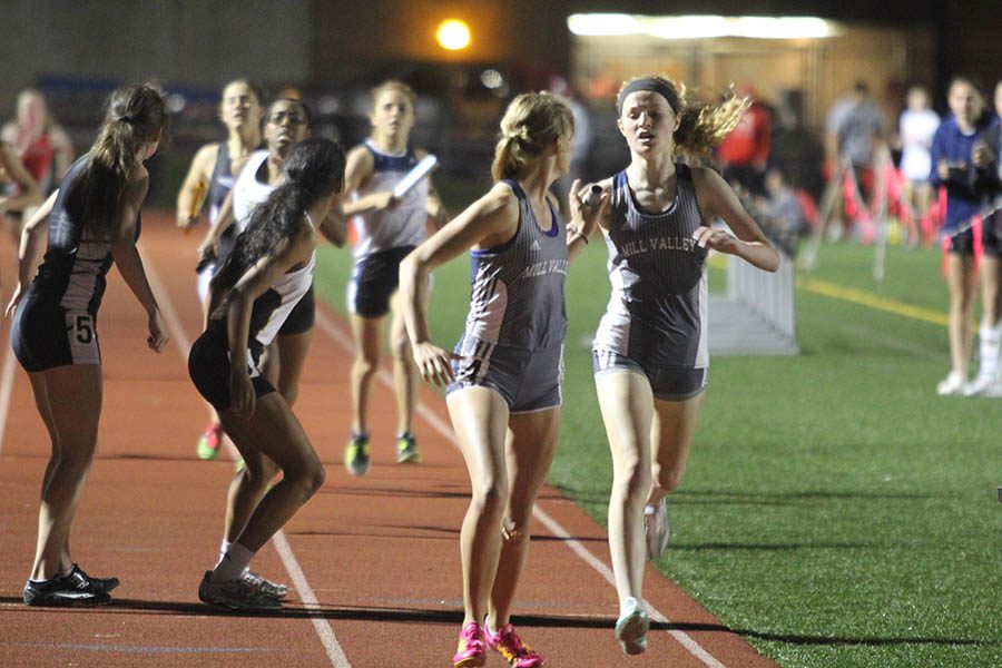 During the 4x400, senior Bella Hadden grabs the baton from her teammate. 