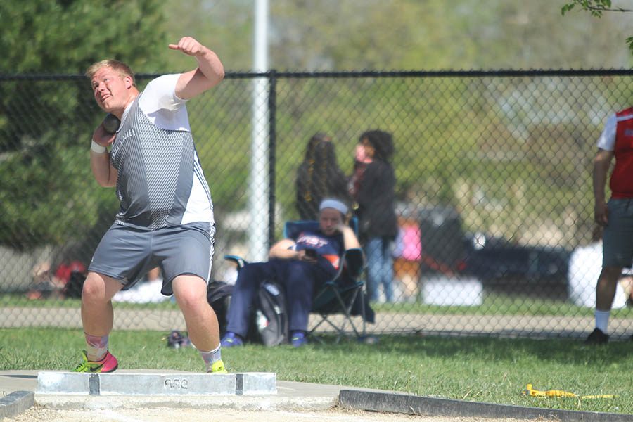 During the meet, senior Trey Callahan throws the shot put.