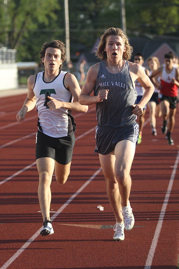 Senior Mitchell Dervin runs past an opponent during his event.