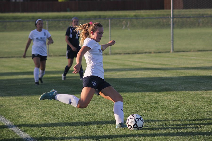 With her eyes on the ball, senior Madison Irish prepares to play the ball to a teammate on Thursday, May 10.