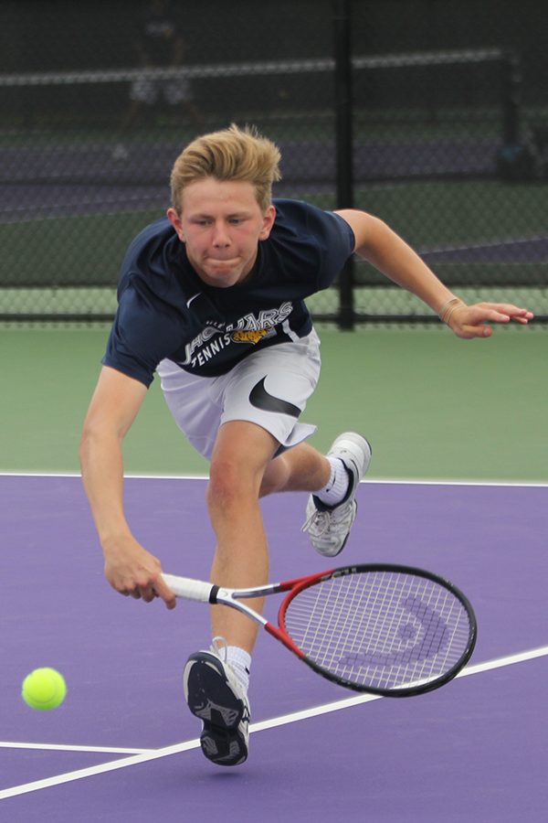 Keeping the ball in play, senior Erich Schulz lunges forward to put backspin on the ball.