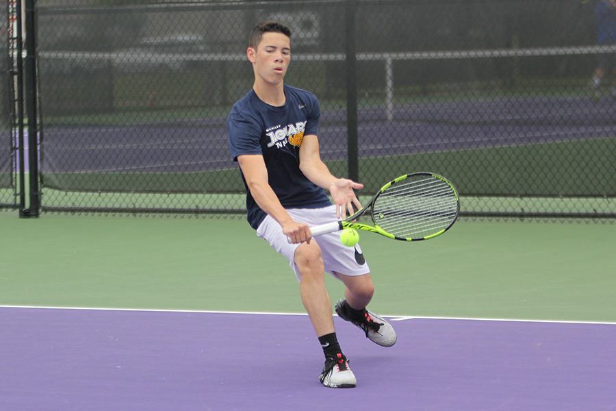 Approaching the ball, sophomore Eric Schanker chops the ball with a one-handed backswing.