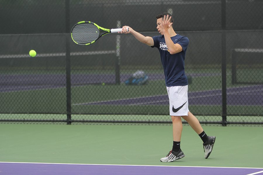 During a rally during his match, junior Eric Schanker completes a forehand swing.