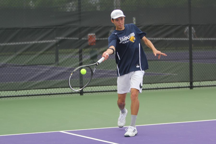 Taking a step into his swing, senior Drake Brizendine makes contact with the ball.