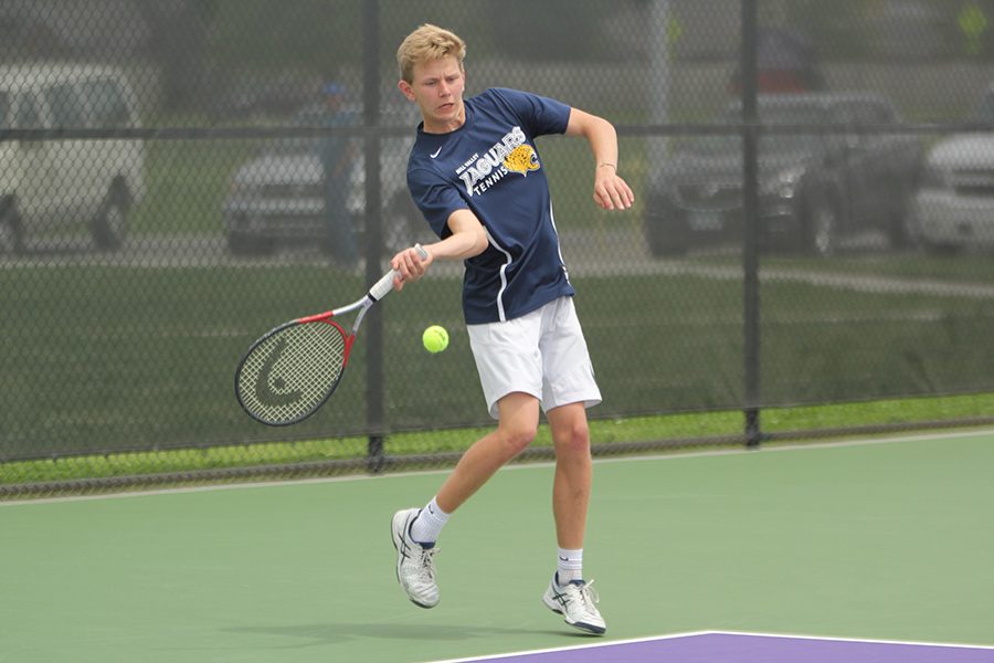 In the first set of his doubles match with senior Landon Butler, senior Erich Schulz hits using his forehand.