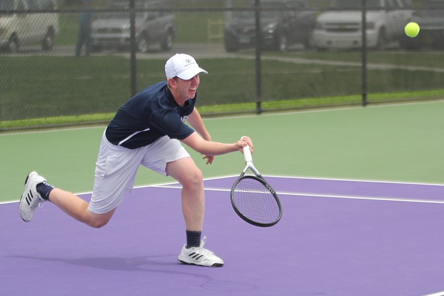 Lunging forward, senior Landon Butler gets underneath the ball to give it some lift while playing against St. James.