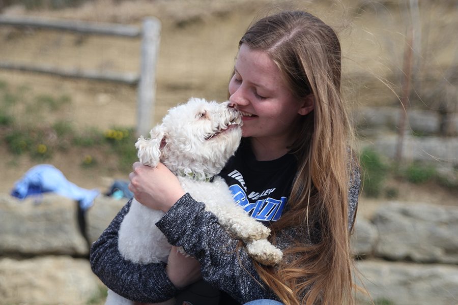 At the Shawnee Mission Park dog park on Sunday, April 22, junior Jordyn Allen holds her dog. “I love having a dog because they are very loyal, Allen said.