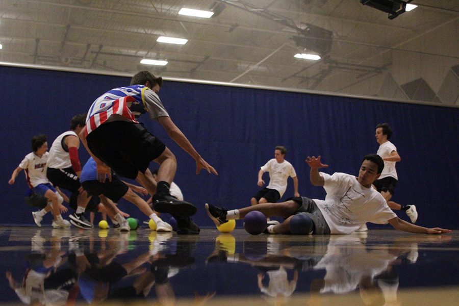 At the start of the game, sophomore Jacob Contreras slides into the center line to grab a ball.