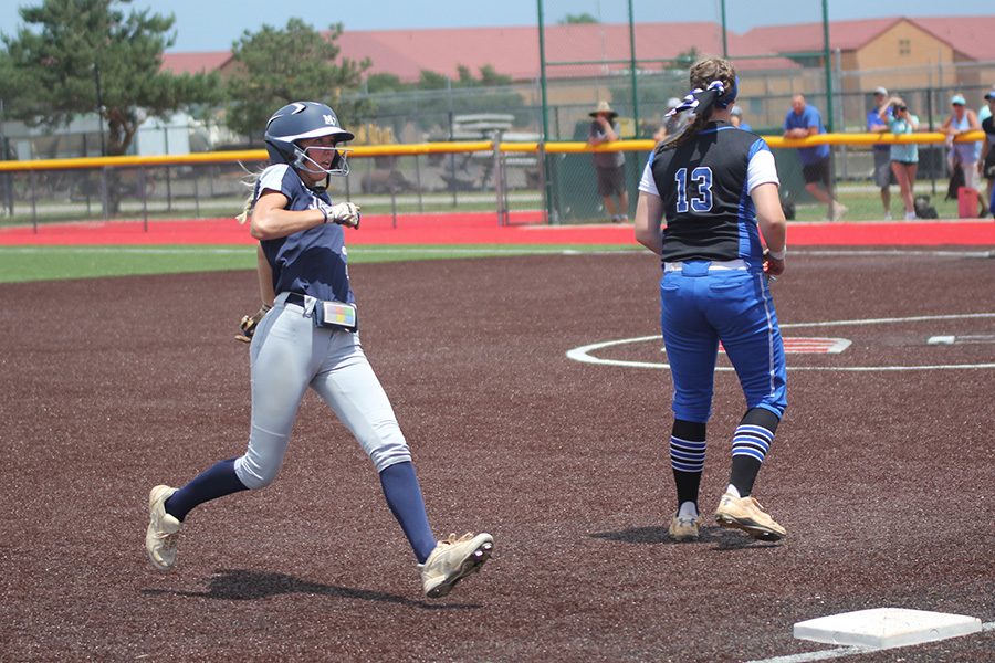 After a hit, senior Lilly Blecha runs into third base. 
