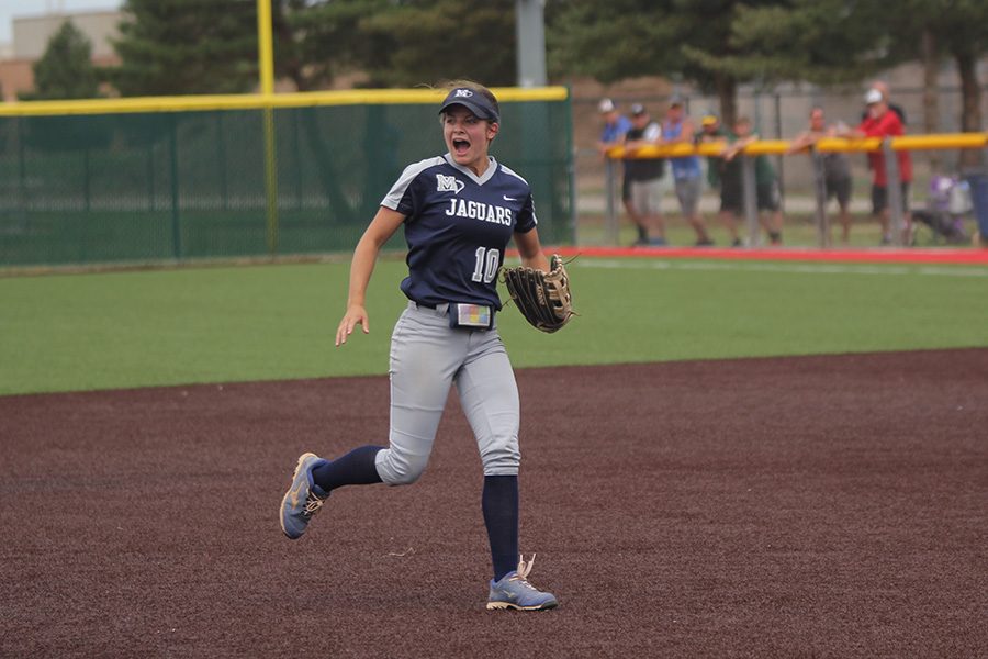 After beating Goddard 7-4, junior Payton Totzke runs to celebrate with her teammates. 
