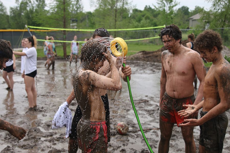Students wash off the mud.