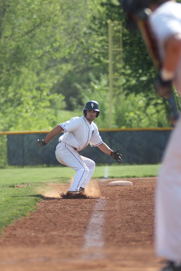 With his teammate up to bat, sophomore Isaac Ammann prepares to run home to score.