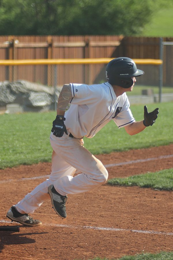 After hitting the ball, Senior Will Morris runs to first base. 