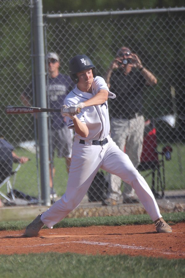 Keeping his eye on the ball, senior Cole Abram swings to get a hit.