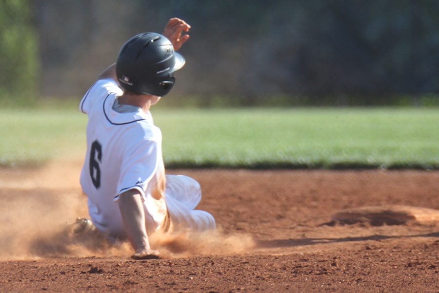 After a hit, senior Cole Abram slides into second base to avoid getting out.