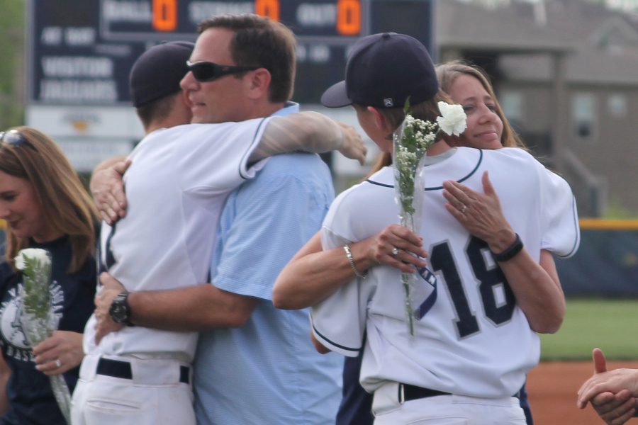 After being recognized on senior night, senior Andrew Sumner embraces his mother. 