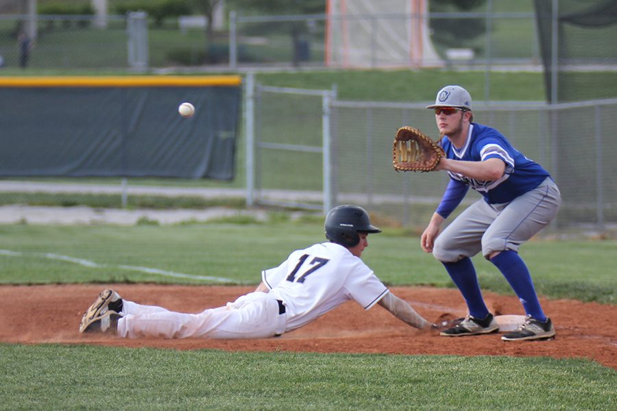 Sliding back to first, senior Will Morris avoids being called out.