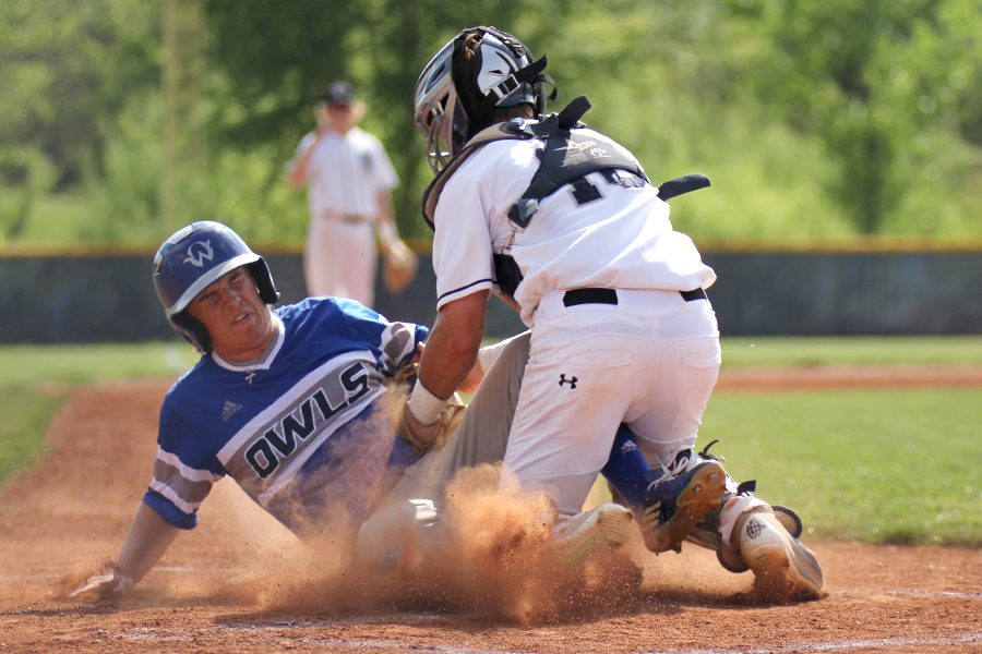 With the ball thrown in from the outfield, junior Ethan Judd turns and attempts to tag an Olathe West player out at home. The Jaguars defeated Olathe West 4-2 on Thursday, May 10.