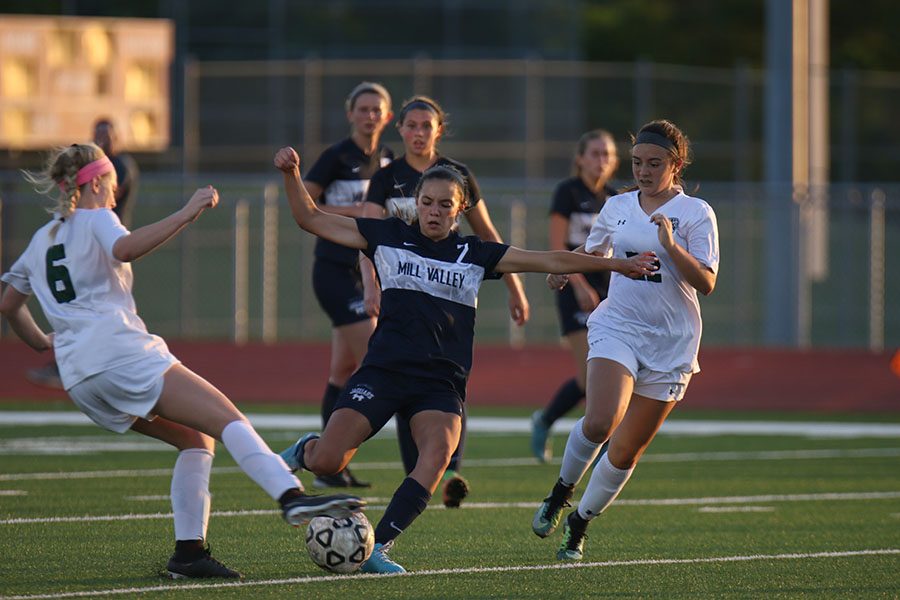 Dribbling the ball, freshman Peyton Wagoner passes her opponents on Tuesday, May 22. The girls beat the De Soto Wildcats 2-1 and will play in Topeka on Friday and Saturday for the state title.