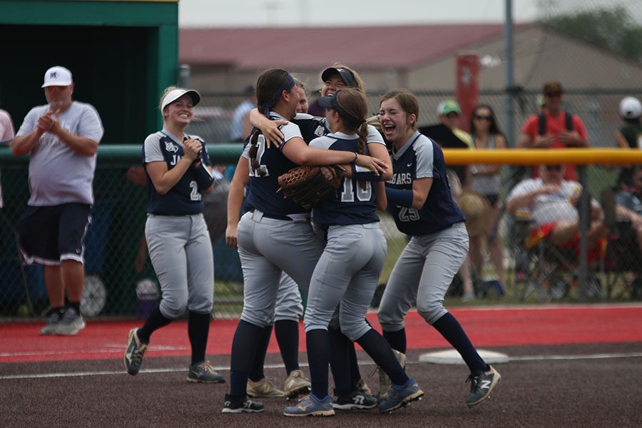 After winning the first state tournament game on Thursday, May 24, the team huddles to celebrate. The team beat Goddard High School, 7-4. The team will play again tomorrow at 11:00 AM.