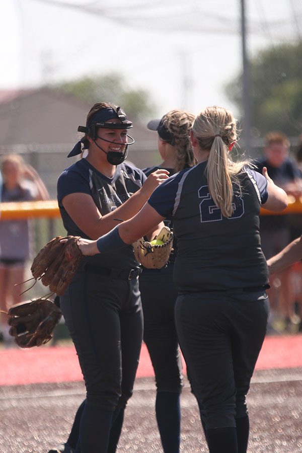 During a timeout, sophomore Lauren Florez and senior Grace Abram show off their handshake.