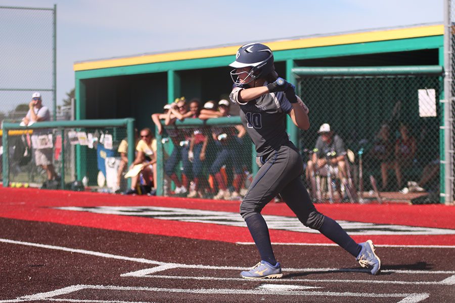 As she steps forward, junior Payton Totzke attempts to hit the ball.