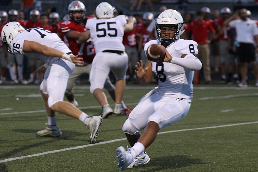 After connecting with a player, senior Jordan Preston throws the ball to a teammate. The Jaguars defeated Blue Valley West 35-24 on Friday, Aug. 31. “ This is the tone setter [and] this shows the EKL that were coming were ready to go and excited to finish the season” said Preston.