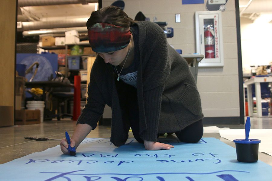 After coming in for a StuCo workday on Sunday, Jan. 8, student body President Hannah Barnes paints a sign for the winter homecoming dance. “Creating diverse event opportunities will help get all areas of the school involved,” Barnes said.