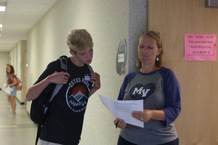 Math teacher Amy Welzenbach checks to see if a incoming freshman is in her class. 