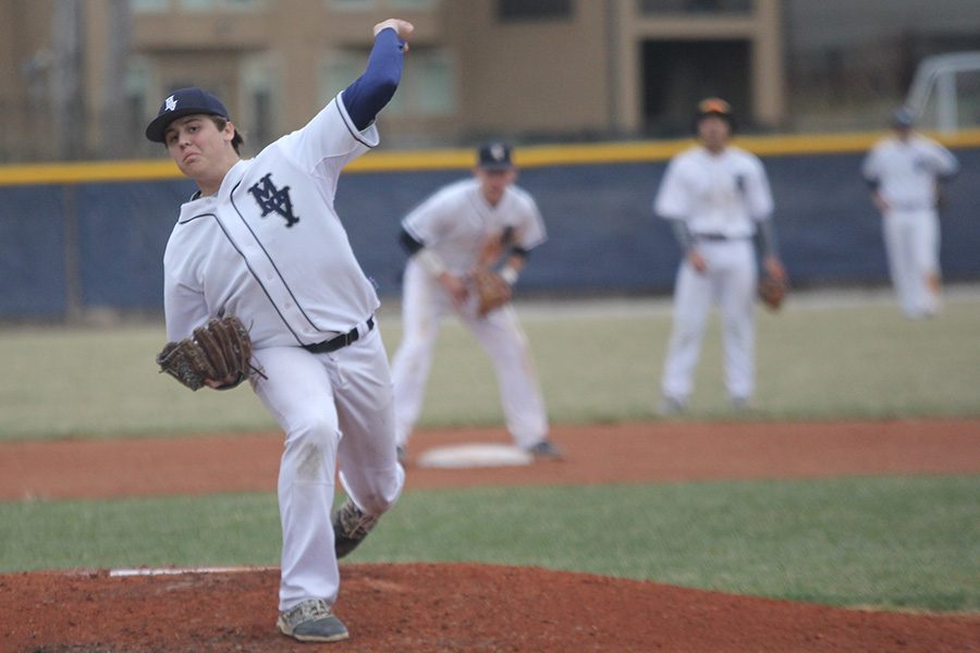 Tossing a pitch during a game against SMW in the 2018 season, senior Nolan Sprague works to strike a batter out on Friday, March 23. After pitching five innings, Sprague led the team to a 4-1 victory.  