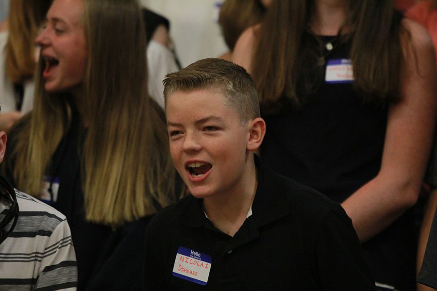 As the crowd shouts Hey, hey, what do you say?, freshman Nicolas Strauss joins in the chant.