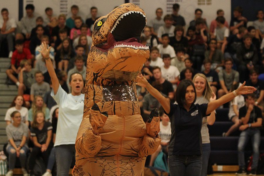 Dressed as a dinosaur, business teacher Nicole Porter dances with fellow teachers. 