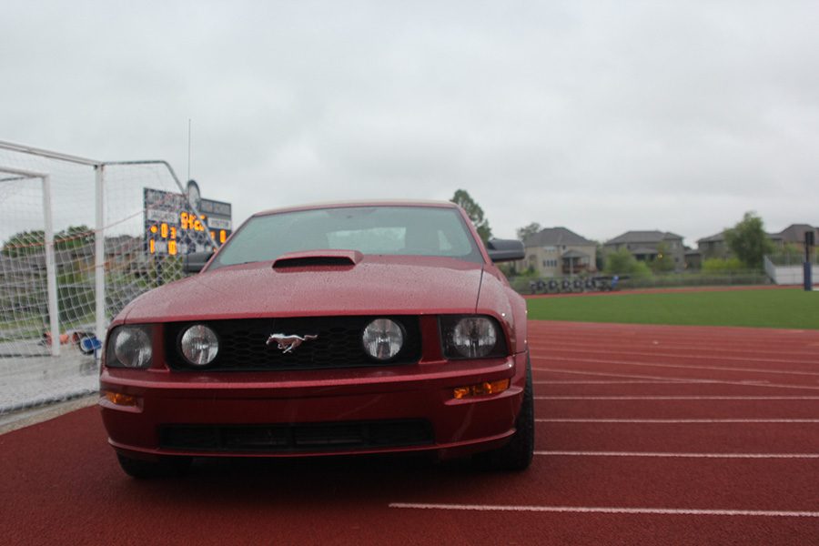 At+the+end+of+the+line+of+cars+sits%2C+Noah+Smith+and+Payton+Totzkes+red+mustang.