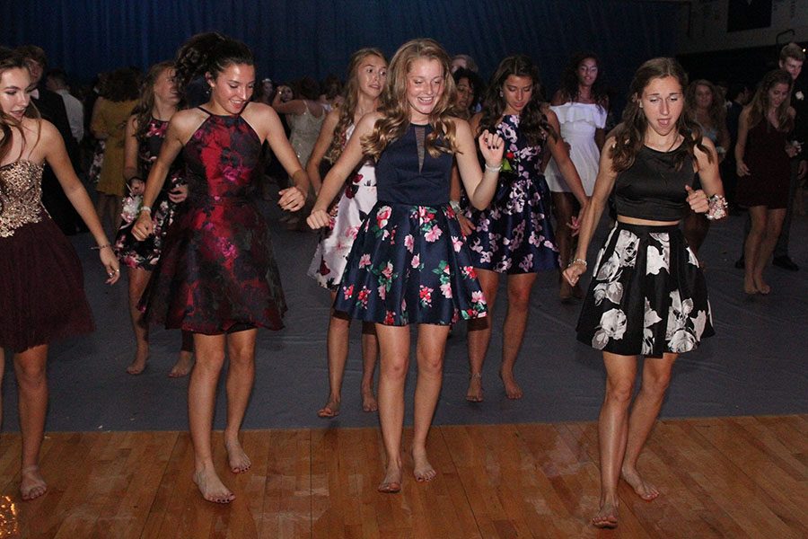 Freshman Quincy Hubert, juniors Jenna Walker and Morgan Koca dance along to a choreographed dance. 