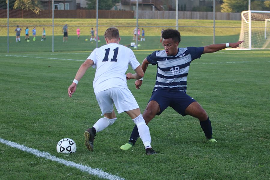 Working around the legs of an Aquinas player, senior Baith Abdullah tries to get the ball away. The soccer team won 2-0 against Aquinas on Tuesday Sep. 11. “Winning meant a lot, because they had a lot of corners and a lot of throw ins, where I had to challenge myself to get the ball in the air,” Abdullah said.