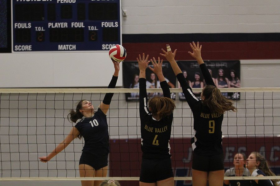 In the second set of the night, sophomore Molly Carr, spikes it towards two players from Blue Valley. We mainly struggled with our energy, Carr said. We are normally really excited, but these past two games our energy hasnt been where it needs to be.