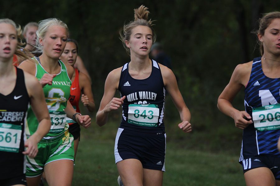 Keeping a lead against the girl behind her, junior Molly Haymaker maintains a good pace for the remainder of the race on Saturday, Sept. 29th.