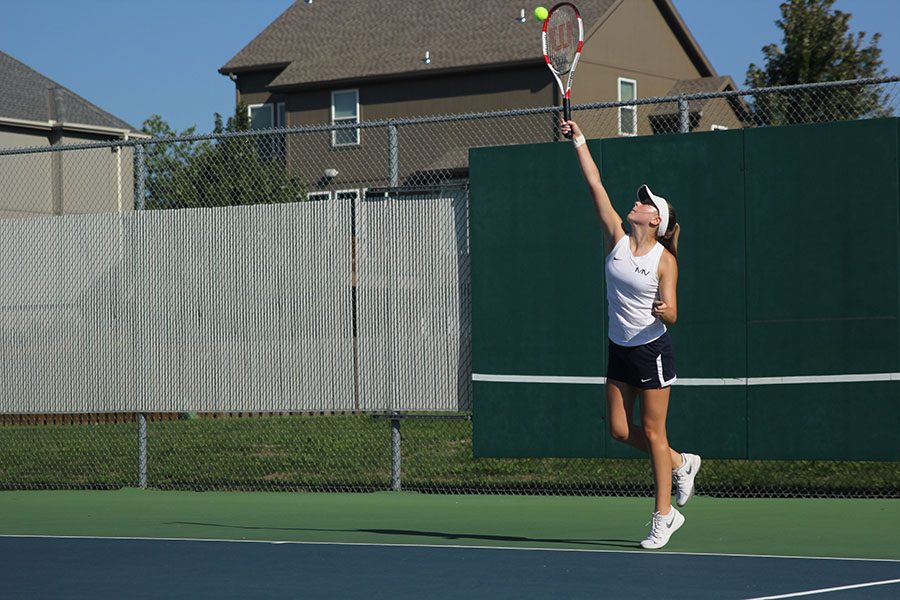 Serving in her doubles match, junior Sydney Day puts forth a powerful hit. ”Our match was really close. We went into a tiebreaker but ended up losing in the end,” Day said.