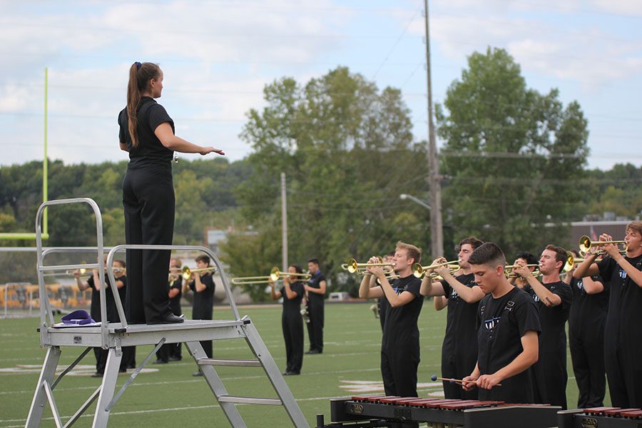 Looking out over her peers, senior Marah Shulda directs the band on Wednesday, Sept. 19th at the Bonner Springs High school competition. The Jaguar band performed their routines and received a two rating. We did really well today, Shulda said. Even though we made some new mistakes Im really proud of our work.
