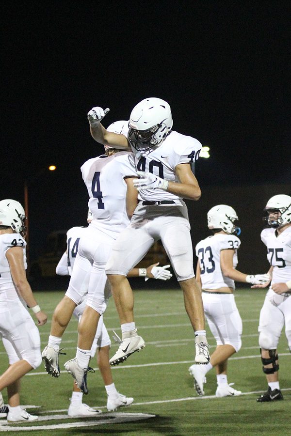After winning the season opener 35-24 against BVW, senior defensive back Cade Clauder and senior wide receiver Dustyn Sweet jump into the air in celebration. 

