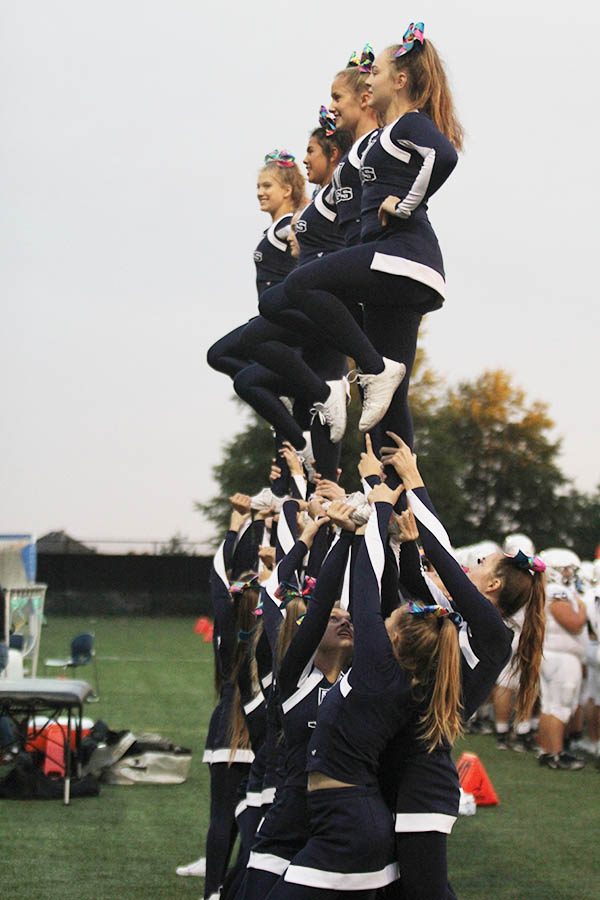 After a big play for the Jaguars, the cheerleaders lift seniors Faith Dmyterko and Mya Johnston and sophomores Caiden Dean and Aryanna Ouellette into the air.