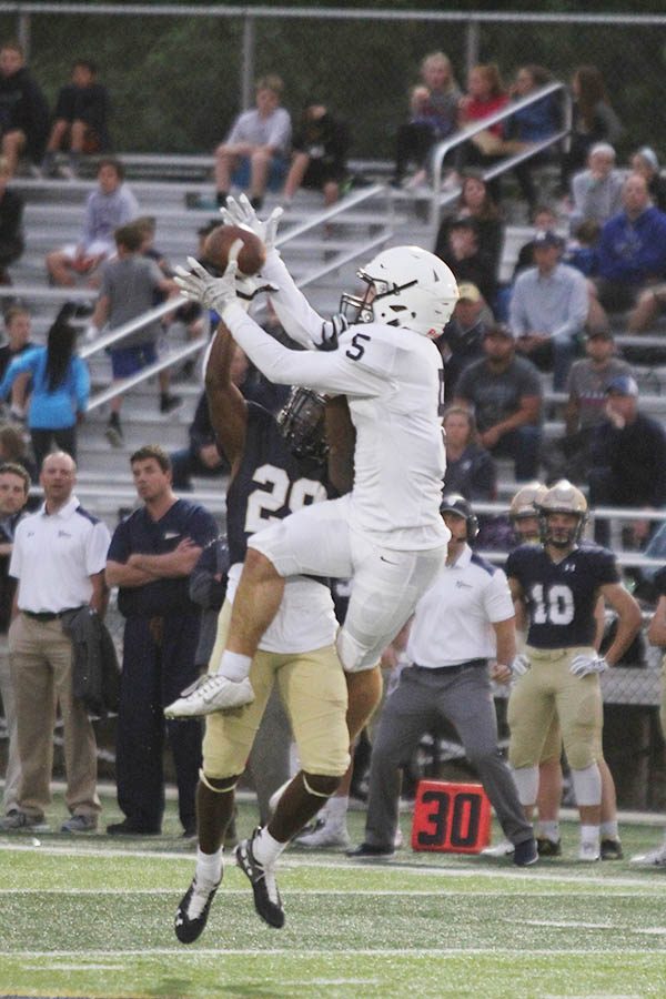 After a long pass from senior quarterback Jordan Preston, senior wide receiver Logan Talley fights off a Saints defender to catch the ball.