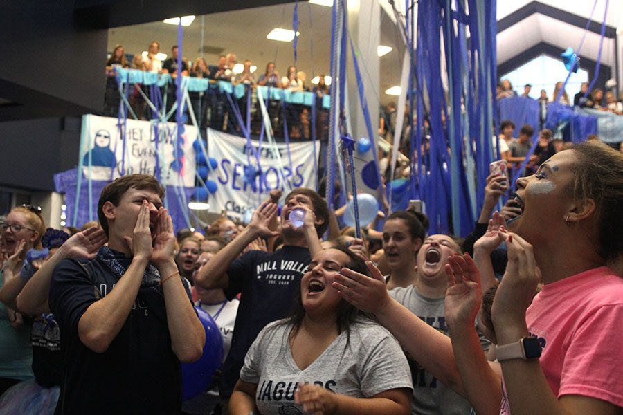 Seniors Noah Smith, Claire Segura and Lucy Graff chant along to the Fight Song.