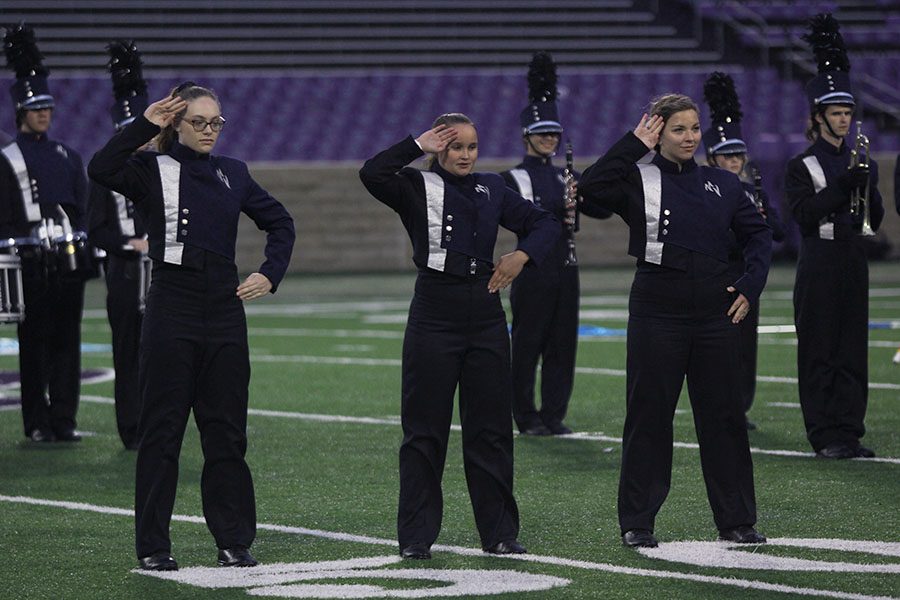 Saluting at the Central States Marching Show at Kansas State University on Saturday, Oct. 6, drum majors junior Amber Guilfoil, senior Marah Shulda and junior Kaleigh Johnston signal the band’s readiness to begin. 