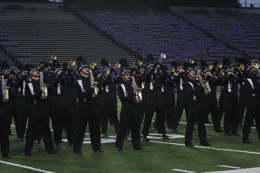 Taking an identical stance, members of the band belt out the last few notes of their performance in “Uprising” by Muse.