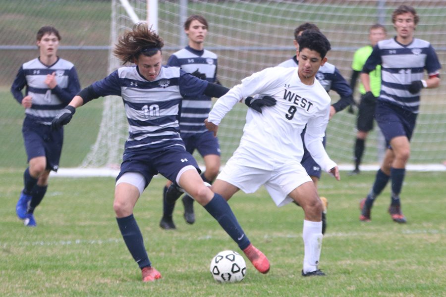 During the first half of the game, sophomore Quinten Blair takes the ball away from a Shawnee Mission West player to move downfield. "I felt the offense could have been better, but I'm still proud." Blair said. The Jags would go on to lose to Shawnee Mission West 3-1.
